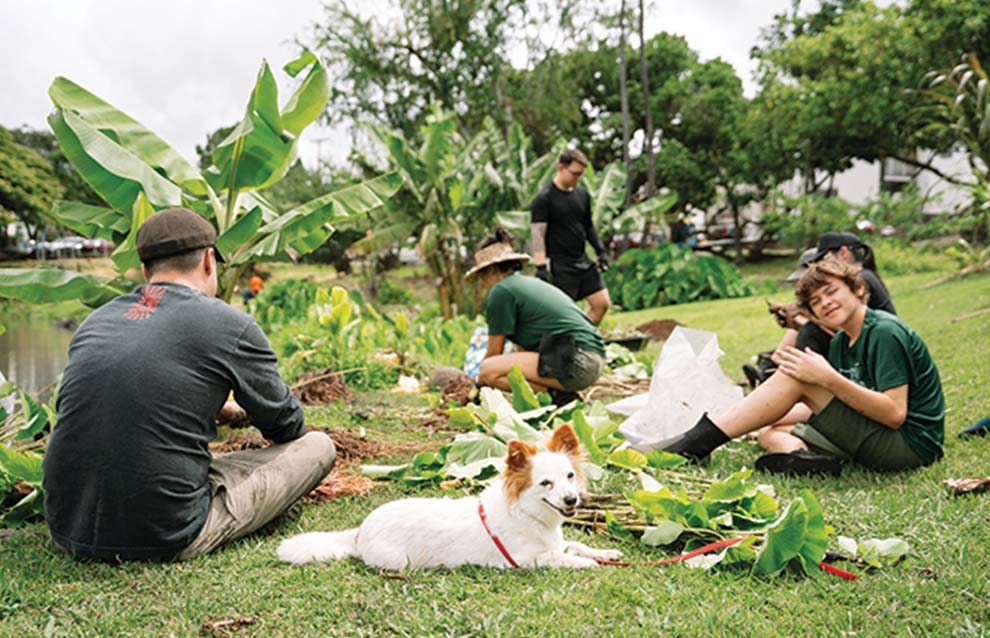 a group of people sitting on the ground with a dog